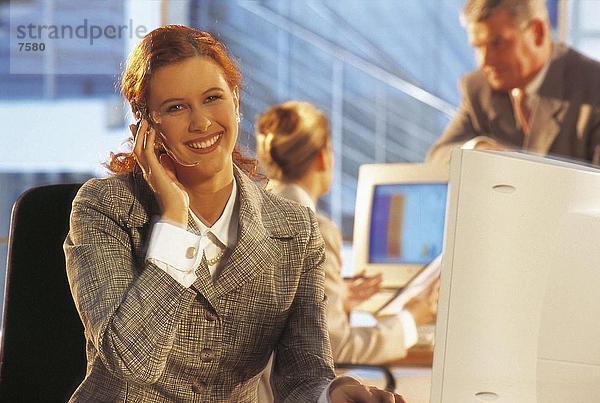 Geschäftsfrau Headset tragen und in einem Büro lächelnd