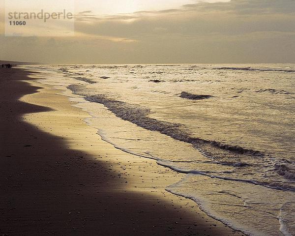 Meereswellen am Strand während der Dämmerung  Niederlande