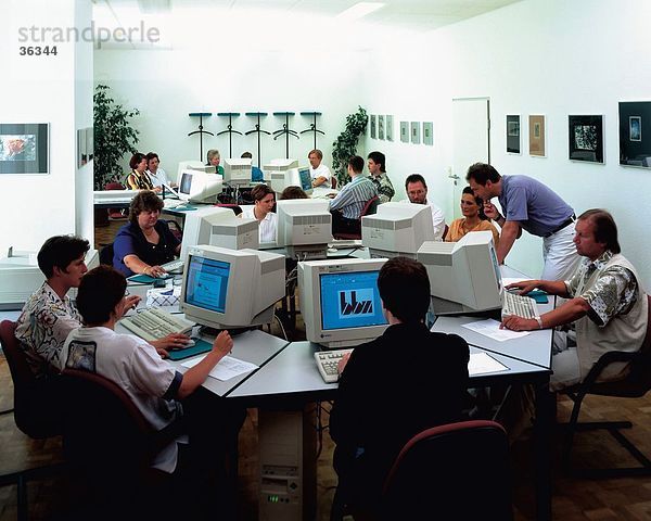 Gruppe von Menschen auf einem Computer in einer Schule