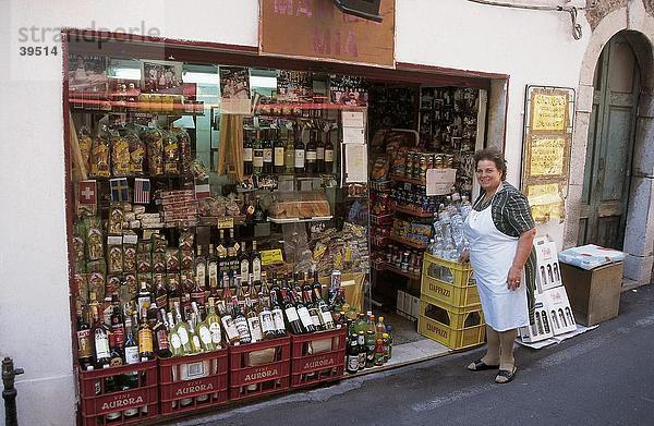 Portrait einer Frau an einem Lebensmittelgeschäft  Taromina  Sizilien  Italien
