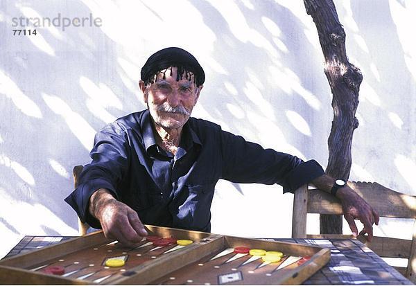 10648039  außerhalb  Backgammon  Gesellschaftsspiel  Griechenland  Kopfbedeckungen  Kreta  Mann  Model released  Porträt  Sariki  Senioren  pl