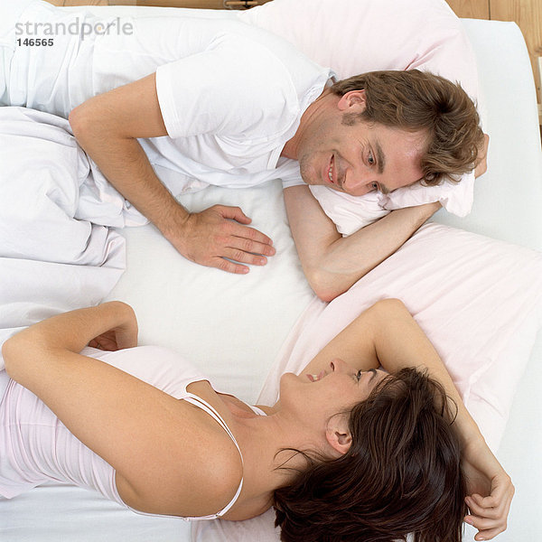 Glückliches Paar wach im Bett