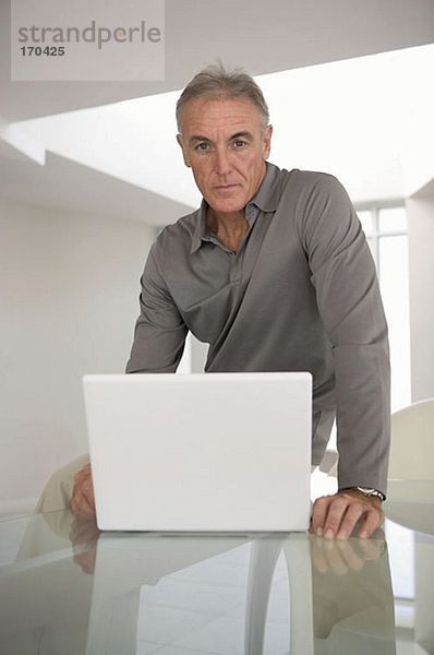 Mann schaut auf Laptop-Computer