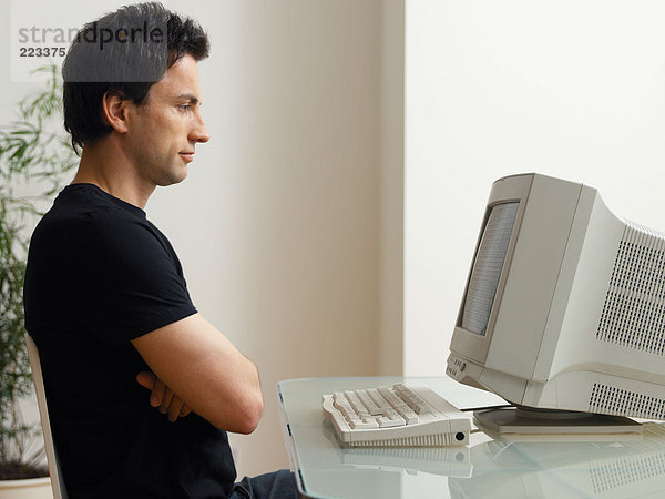Mann schaut auf den Computerbildschirm
