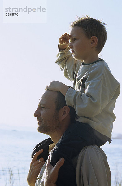 Vater mit Sohn (4-7) auf den Schultern  Nahaufnahme