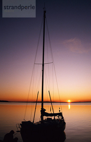 Ein Segelboot und Sonnenuntergang.