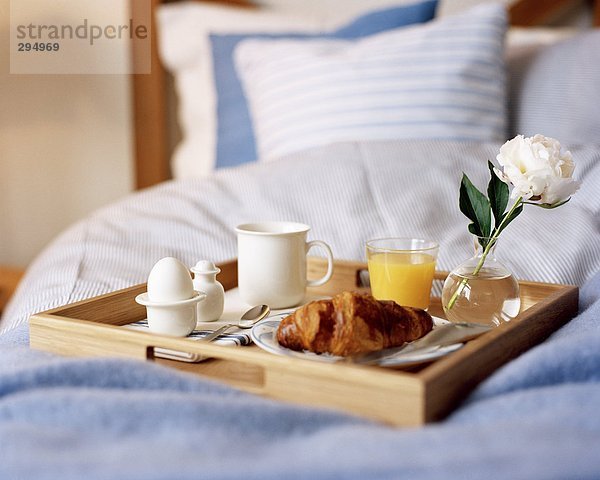 Frühstück auf einem Bett.