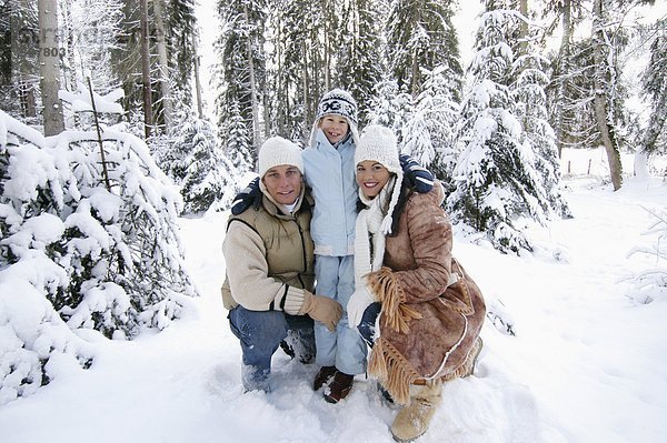 Austria  Salzburger Land  family in snow covered forest