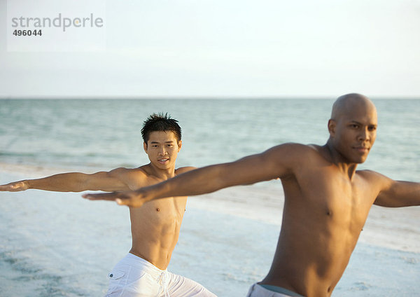 Zwei Männer bei Entspannungsübungen am Strand