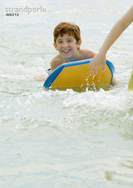 Junge an Bord im Meer