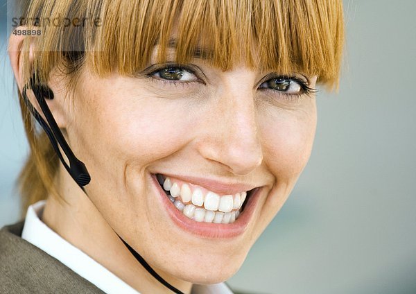 Frau mit Headset  lächelnd