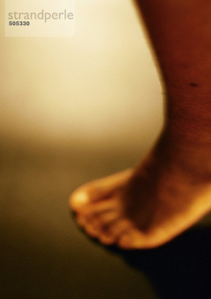 Man's bare foot  close up  blurred