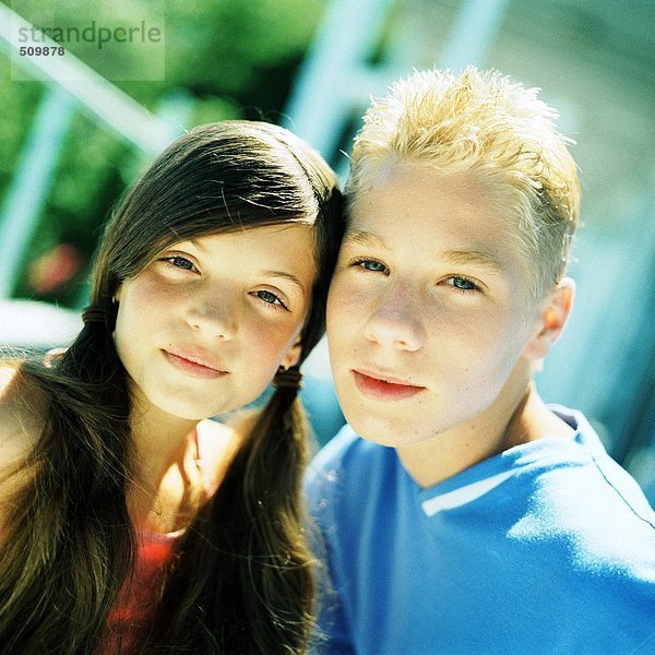 Junge und Mädchen Seite an Seite  Blick in die Kamera