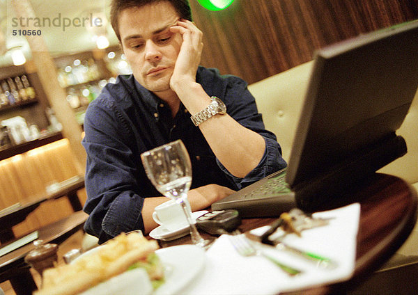 Mann am Kaffeetisch  mit Laptop-Computer