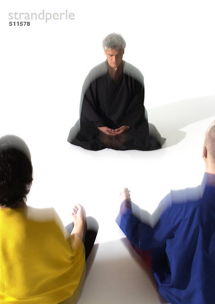 Menschen auf dem Boden sitzend  meditierend  verschwommen