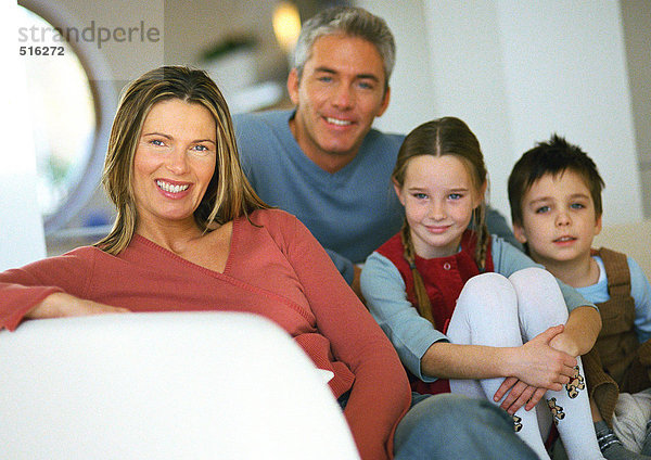 Familie sitzt zusammen auf der Couch  Porträt
