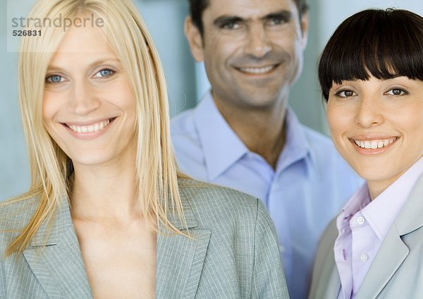Blonde Geschäftsfrau mit zwei Mitarbeitern  Portrait