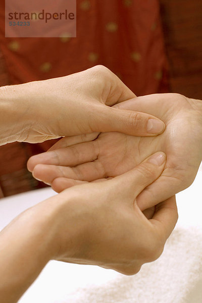 Frau erhält Handmassage