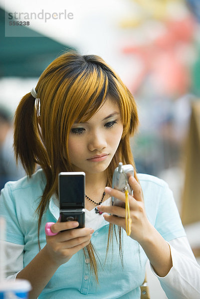 Teenager Mädchen mit zwei Handys