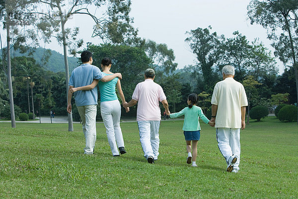 Drei-Generationen-Familienwanderung im Park  Rückansicht