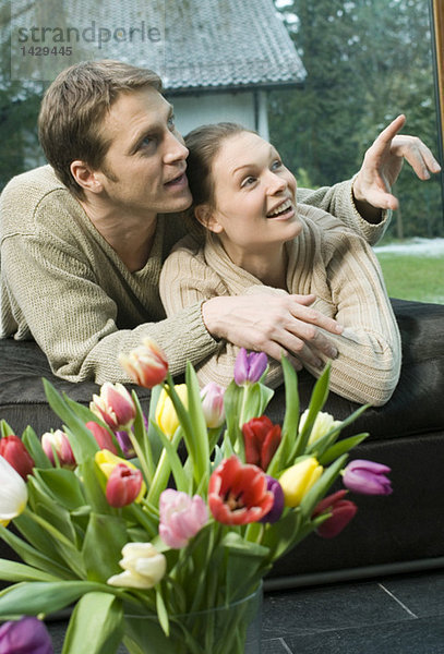 Young man pointing with finger  woman looking closely