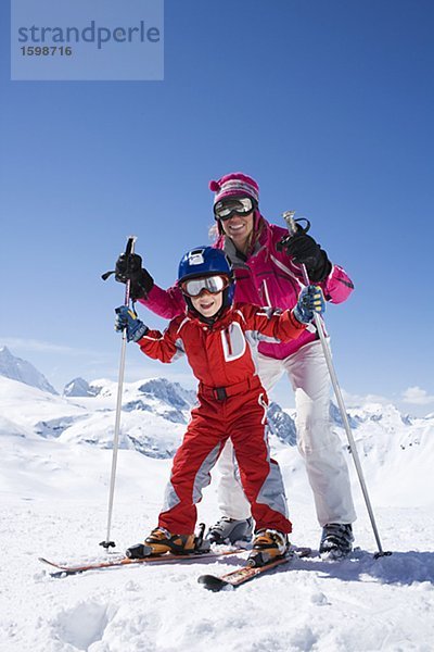 Eine Mutter und ihr Sohn Skifahren.