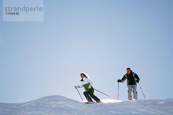 Austria  Salzburger Land  Couple skiing in mountains