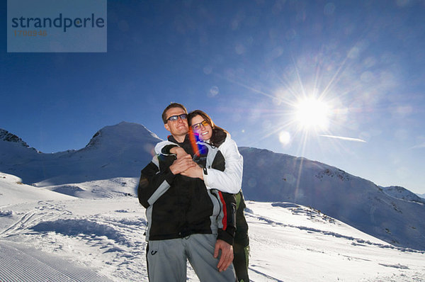 Austria  Salzburger Land  Couple embracing in mountains