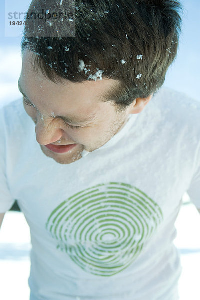 Junger Mann im Schnee  Augen geschlossen  im T-Shirt gekleidet