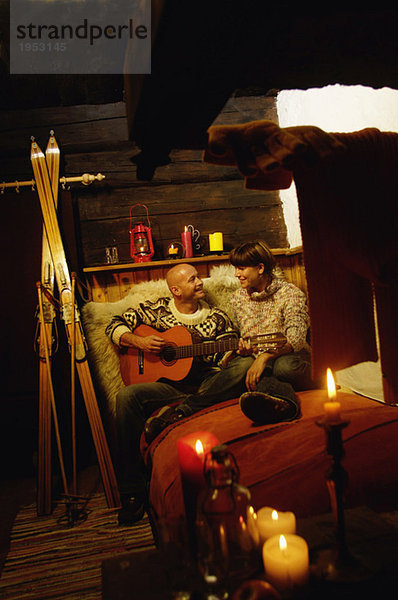 Paar sitzend im Bett in der Almhütte