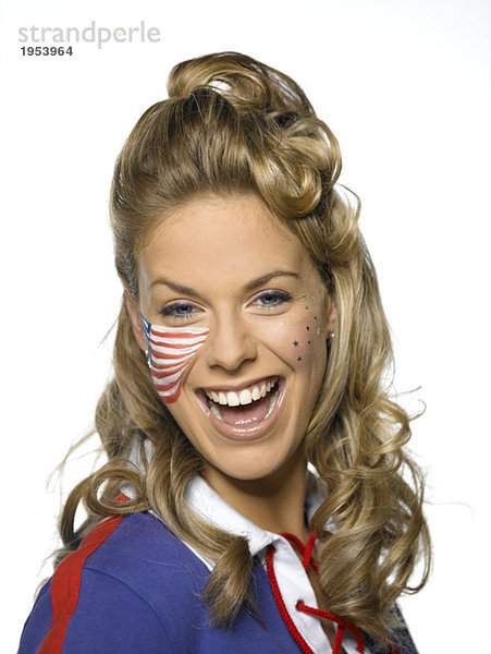 Junge Frau mit amerikanischer Flagge auf Gesicht lächelnd  Portrait