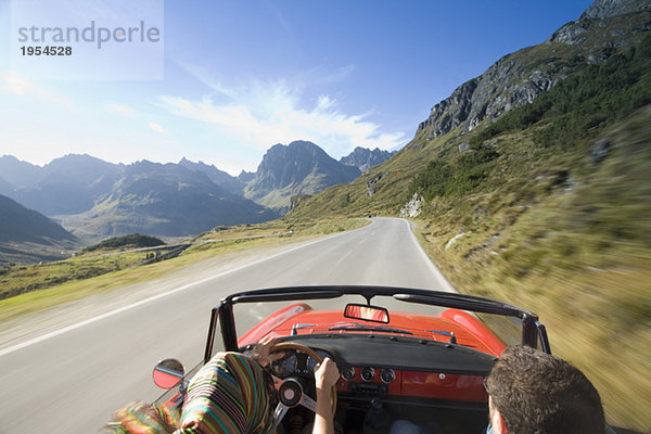 Österreich  Alpen  Paarfahren im Cabriolet  Rückansicht