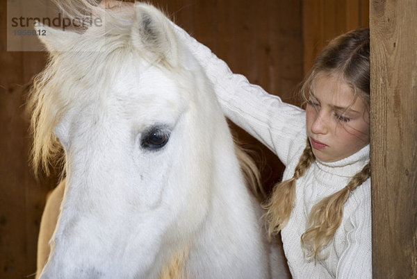 Mädchen streichelndes Pferd