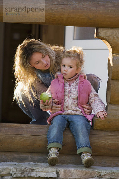 Mother with daughter  daughter holding apple
