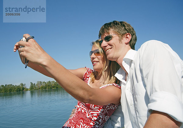 Paar am See  fotografieren sich selbst