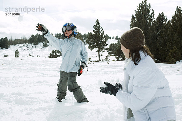 Junge Freunde bei einer Schneeballschlacht  Action-Schuss