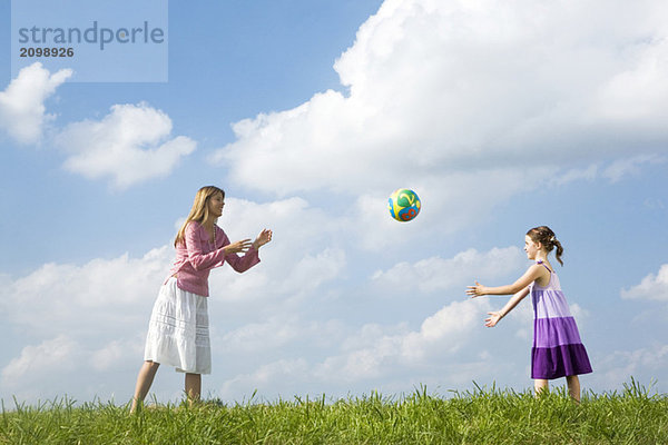 Mutter und Tochter spielen mit dem Ball