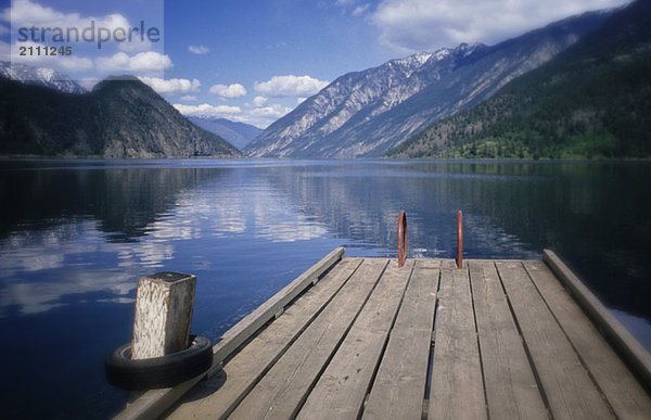 Summer at Anderson Lake  with the old dock in foreground  B.C.