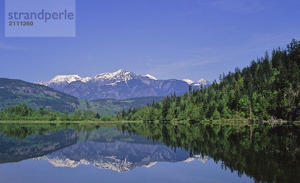 Cayoosh Mountain Range in reflected in One Mile Lake  near Pemberton