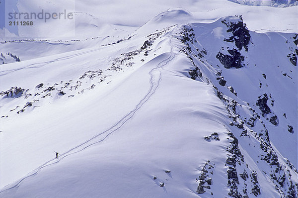 Skier walks up Piccolo Mtn  fresh winter snow  Whistler  B.C.