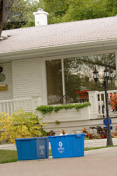 Blue recycling bins in front of house  Regina  Saskatchewan