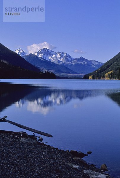 The mountains above Carpenter Lake are reflected in early winter  BC