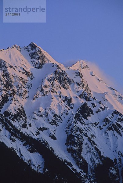 Mount Currie rises above Pemberton Valley  alpenglow lights snow  Pemberton  BC Canada