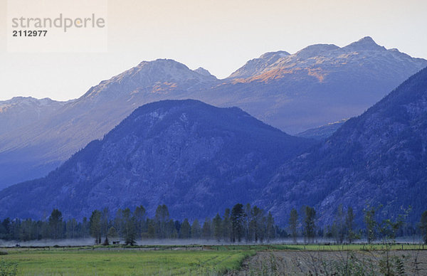 Mountains rise in late summer day above Pemberton Valley