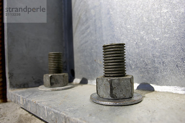 'Nut  bolt  and washer attached to steel frame