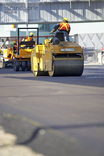 'Steam rollers paving new asphalt