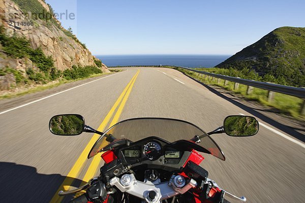 View on Motorcycle in action on Cabot Trail  Cape Breton Highlands National Park  Nova Scotia  Canada