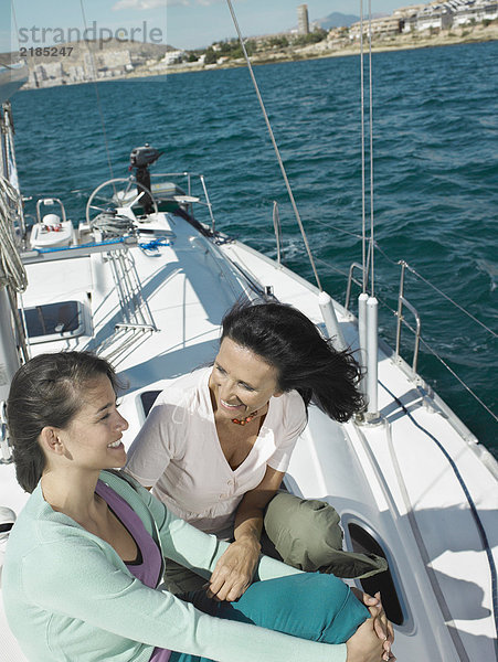 Reife Mutter und Tochter entspannt auf der Yacht  lächelnd