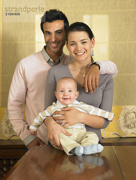 Junges Paar und kleiner Sohn (1-3 Monate) lächelnd  Portrait