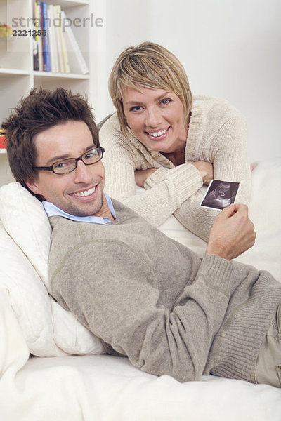 Couple  Man holding ultrasound photos